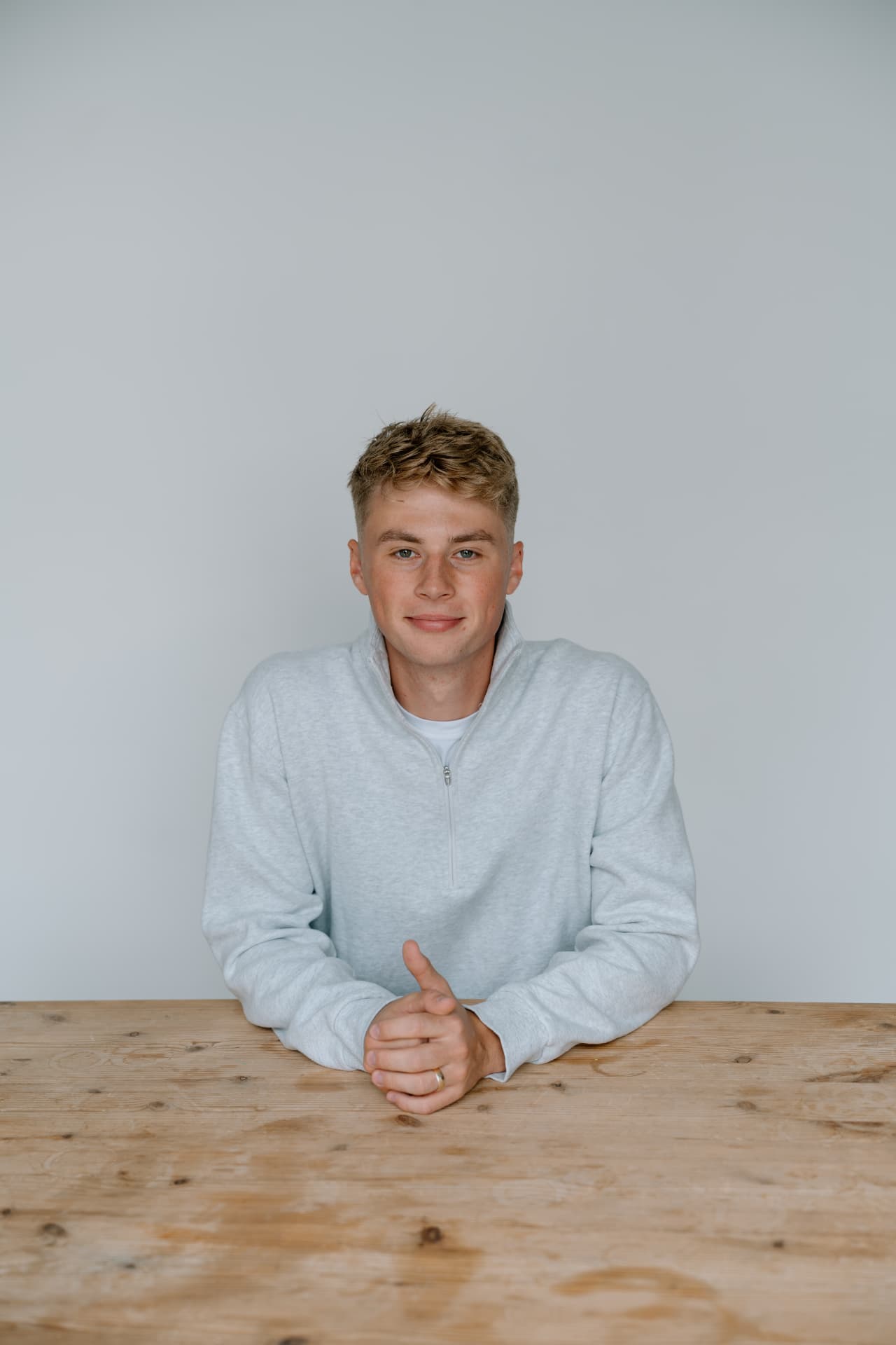 Matt Schertzer, licensed professional counselor, seated at a wooden table and looking at the camera.